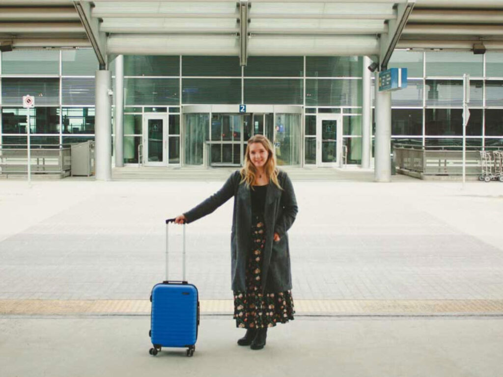 Author Taylor holding on to her baggage at the Winnipeg Airport