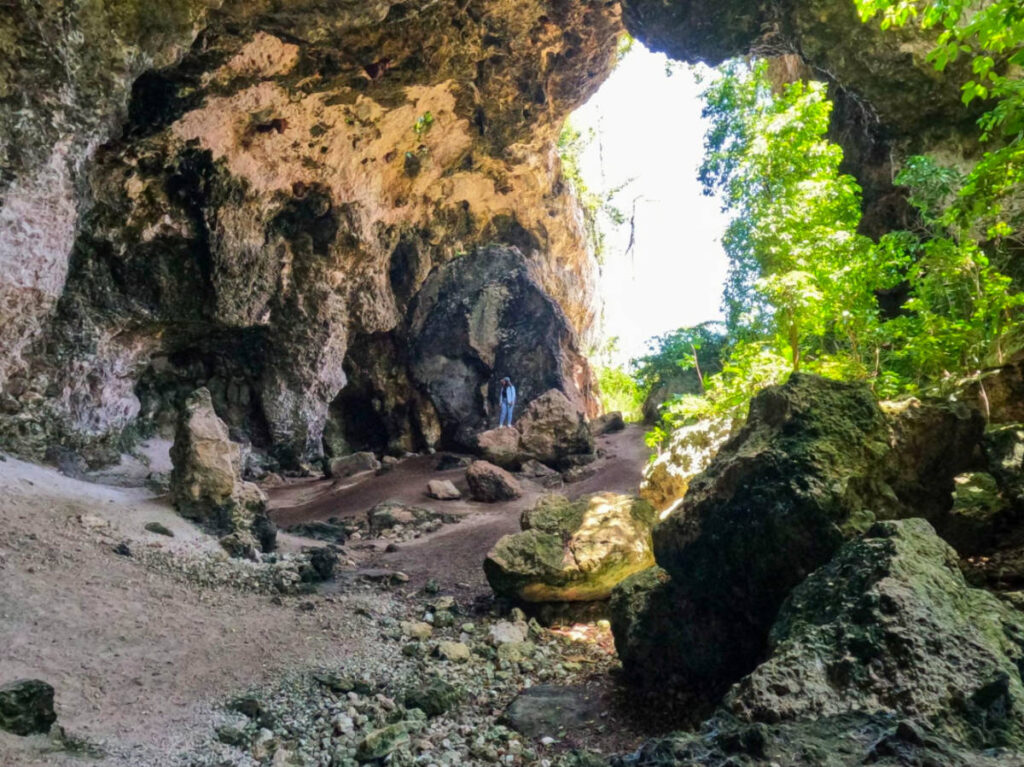 Author Vanessa standing on a rock at Cueva Maria de la Cruz