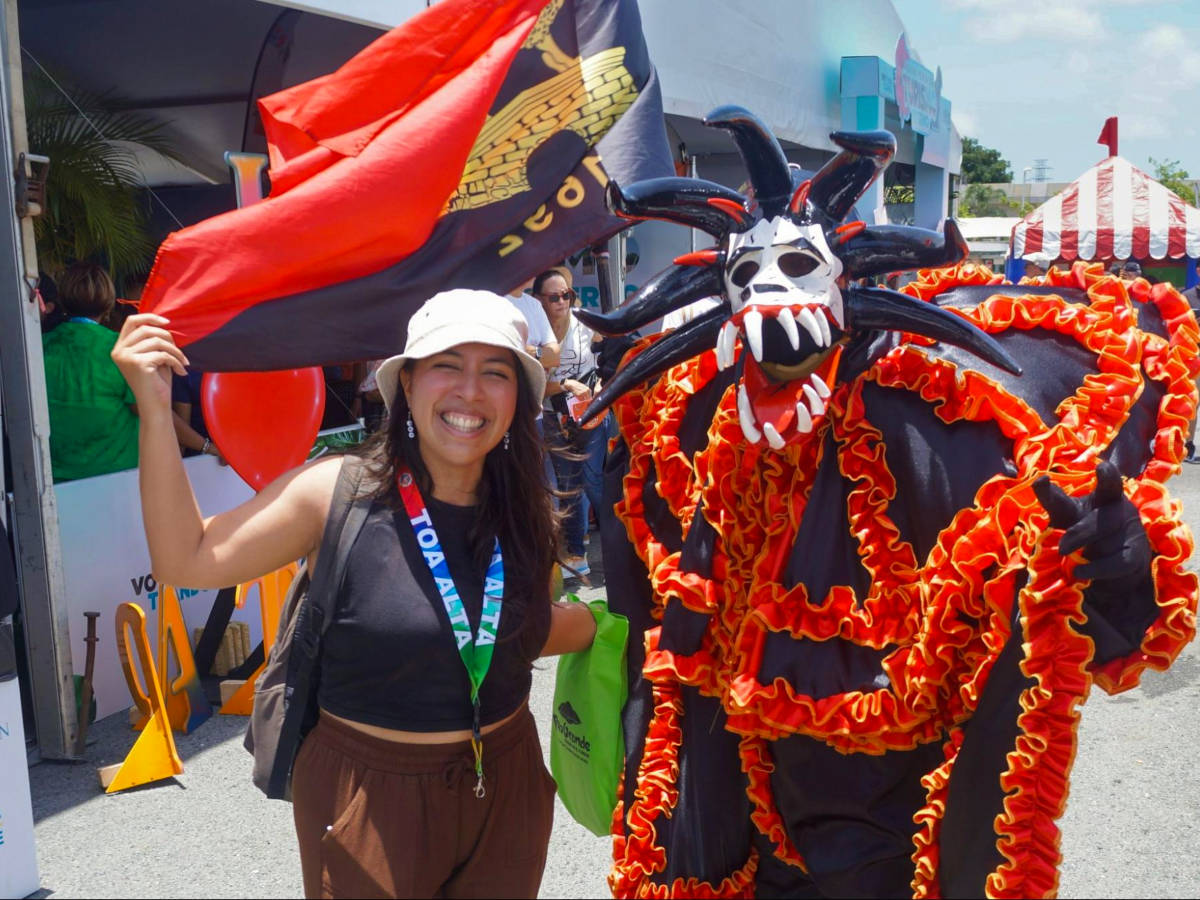 Author Vanessa posing with a Vejigantes at the Ponce Carnival