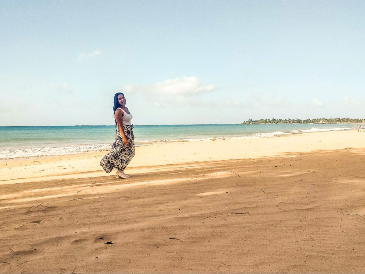 Author Vanessa wearing a dress and posing for a photo at Carolina Beach