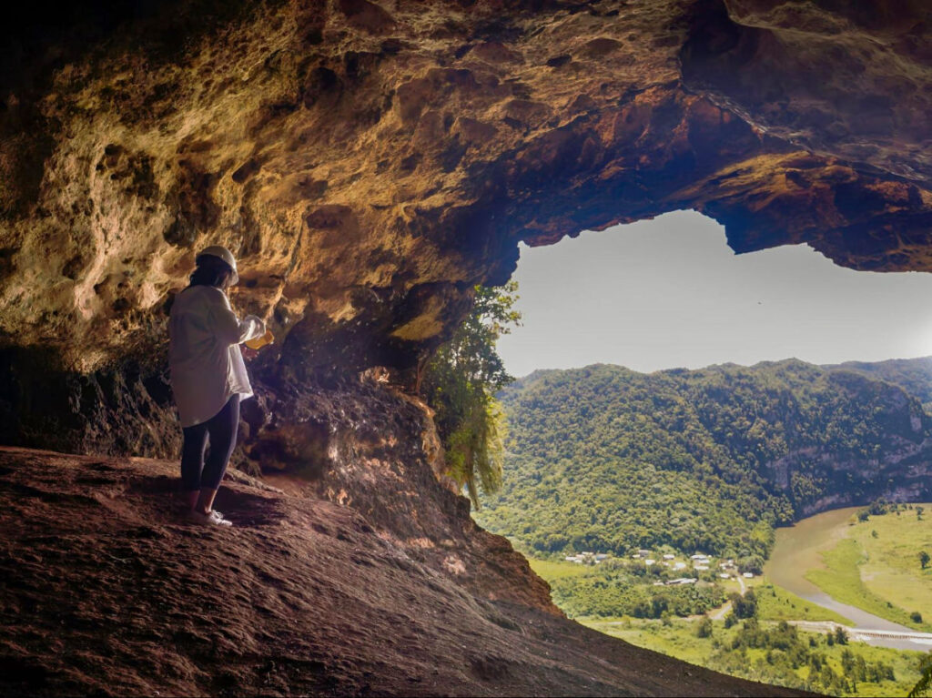 Author Vanessa standing in Cueva Ventana and admiring the view below