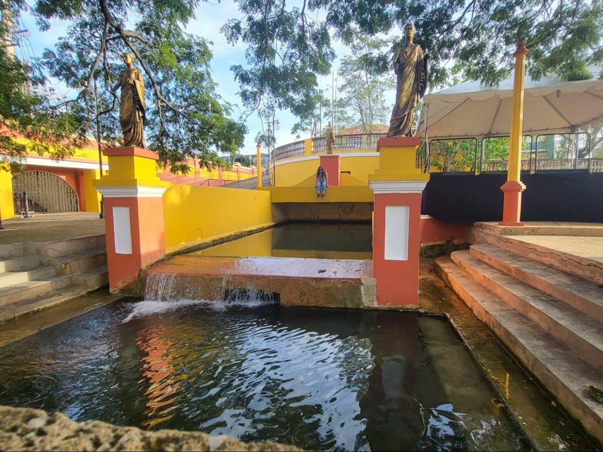 Author Vanessa sitting in El Parterre in Aguadilla Pueblo