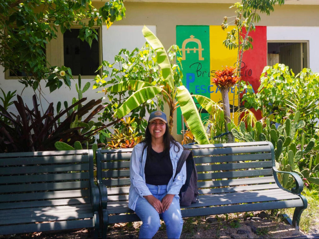 Author Vanessa sitting on a bench in Loíza