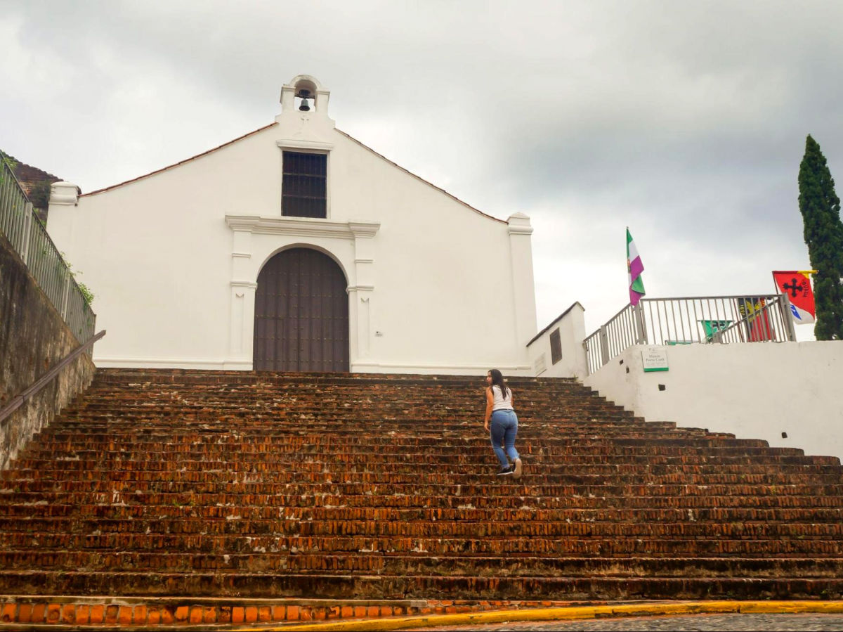 Author Vanessa going up the stairs of Porta Coeli in San Germán