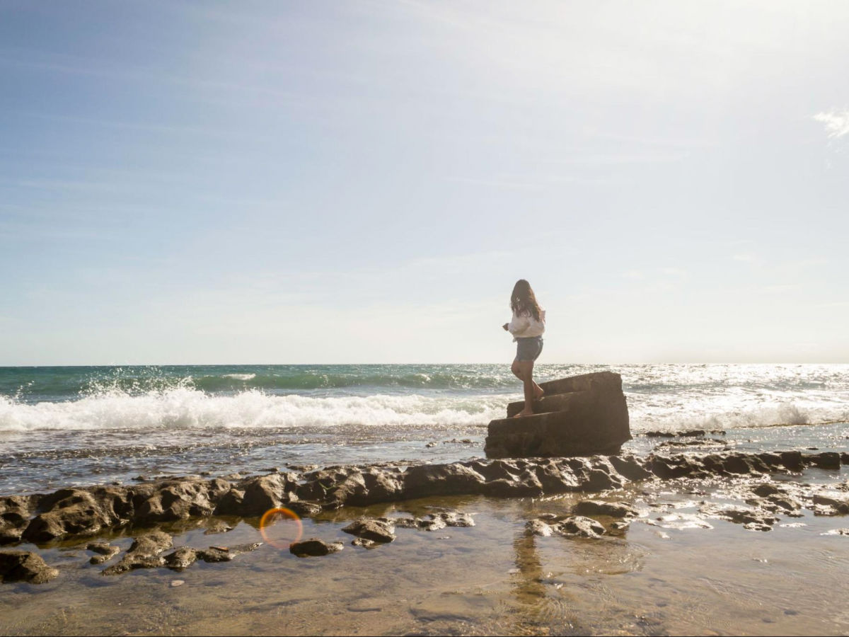 Author Vanessa standing on a staircase from a ruin at Tres Palmas Beach