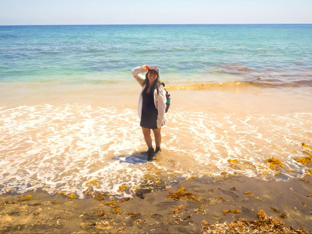 Author Vanessa standing on the Black Sand Beach in Vieques