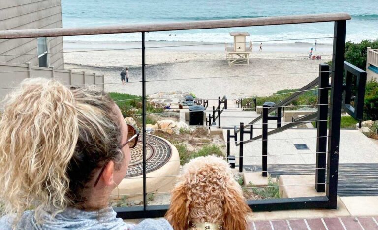 The author and her dog with a view of a beach in Carlsbad