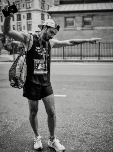 A runner celebrating after his first NYC Marathon
