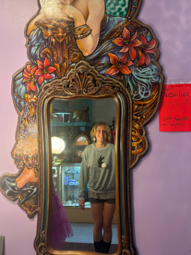 Author's friend wearing a bunny sweater and looking at the mirror