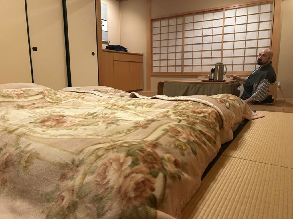 Author's husband sitting at the table in the Ryokan room