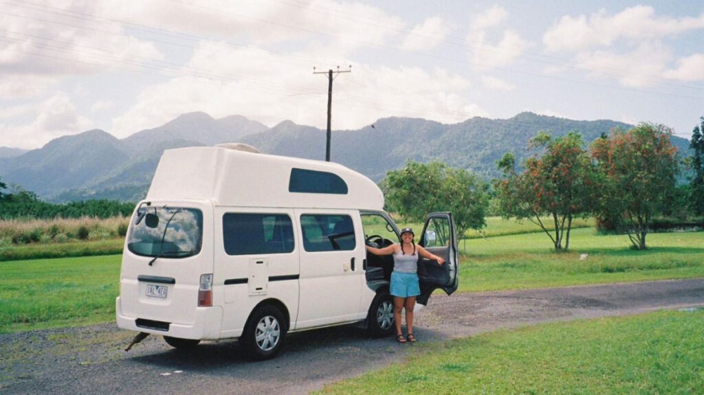 Author's partner posing with their free campervan