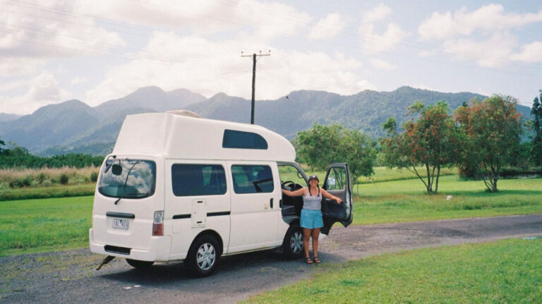 Author's partner posing with their free campervan