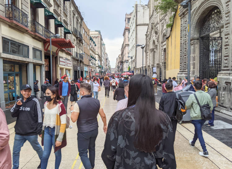 People walking down Avenida 5 de Mayo in Ciudad de Mexico