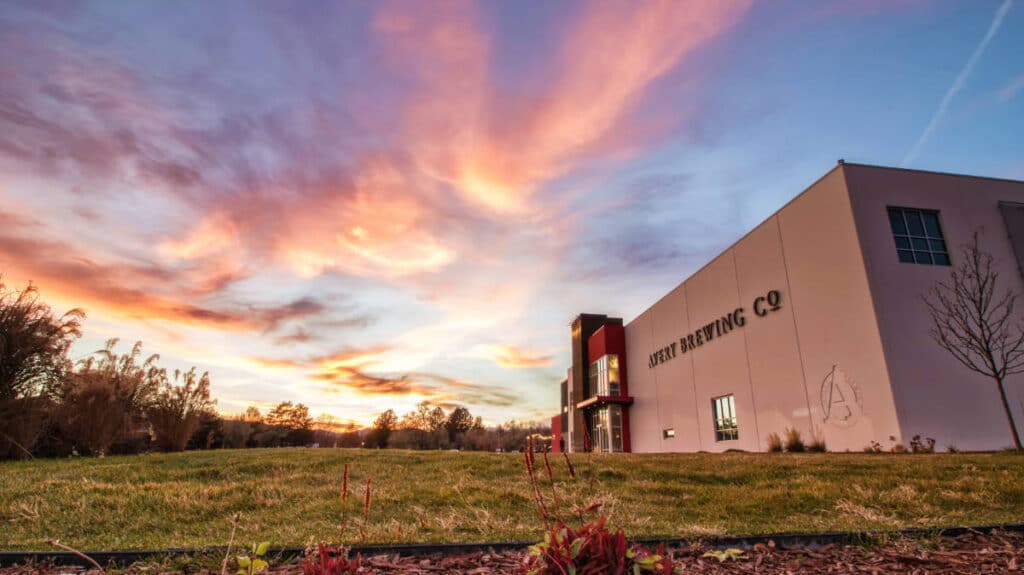 Colorful sky over the Avery Brewing Company building during sunset