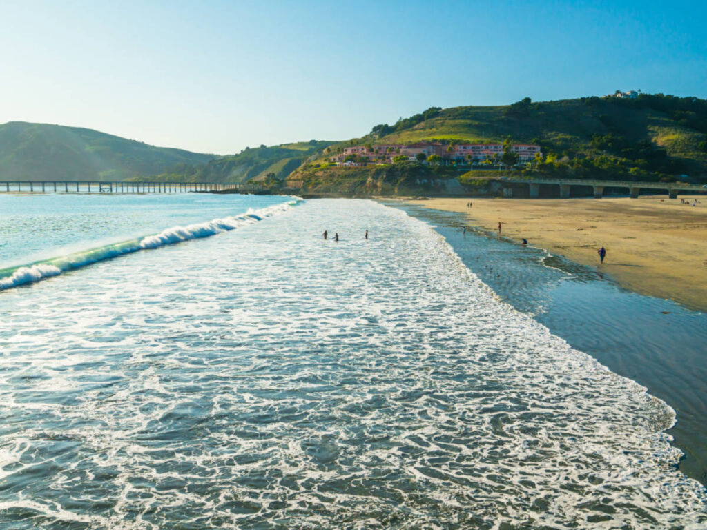 View of the waves crashing to the vast white sand Avila Beach in San Luis Obispo