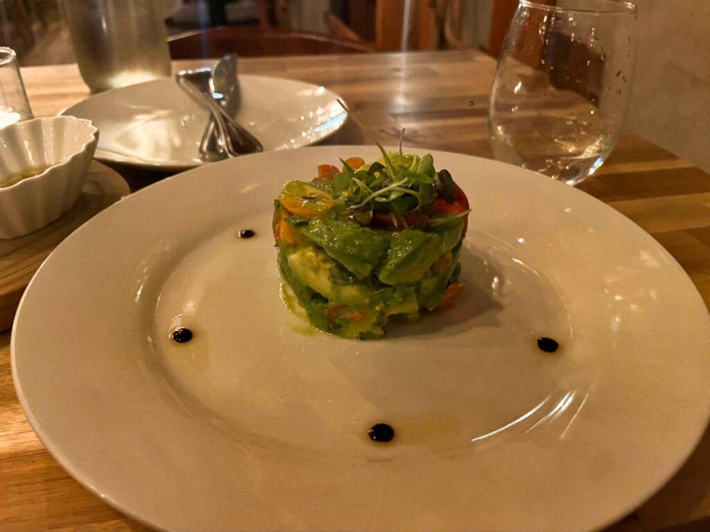 An avocado salad on the plate in Addictive