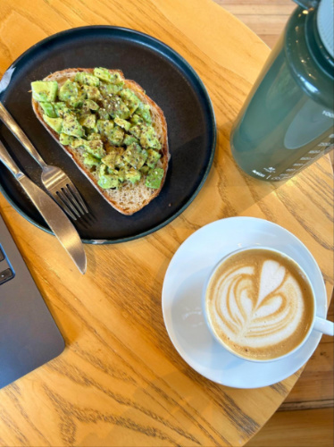 A plate of Avocado toast and a cup of coffee at Huckleberry Roasters