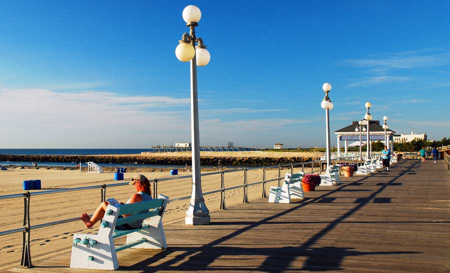 A woman sitting on a chair in Avon-By-The-Sea Beach