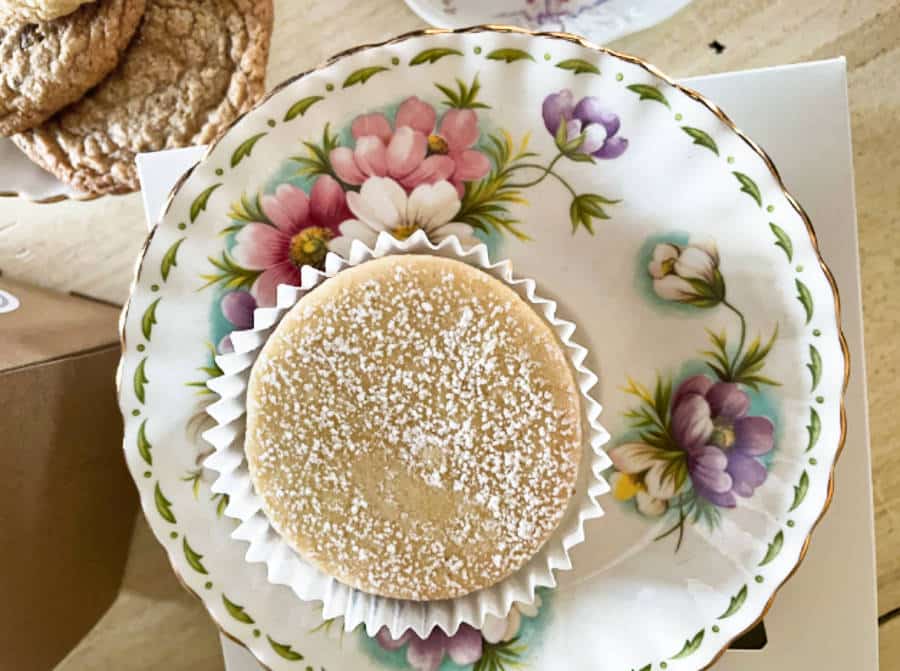 A plate of cupcake and alfajor cookies on the side from Azucar Bakery