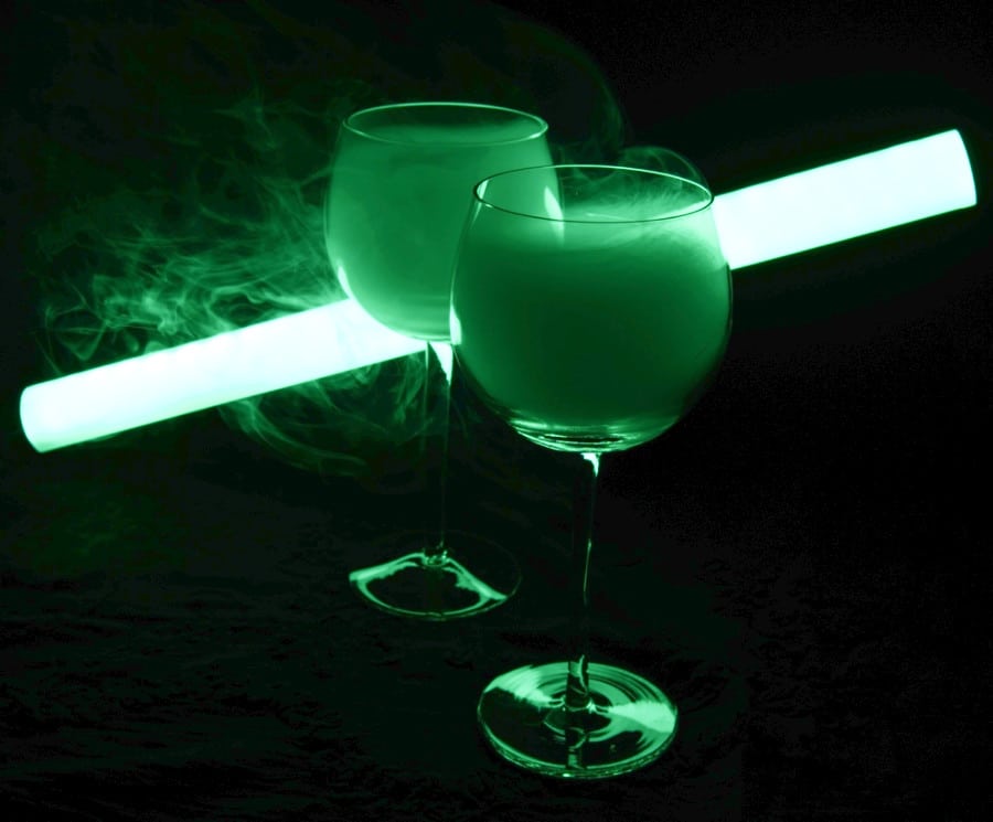 Two martini cocktails in a neon green light with smoke from blackout restaurant