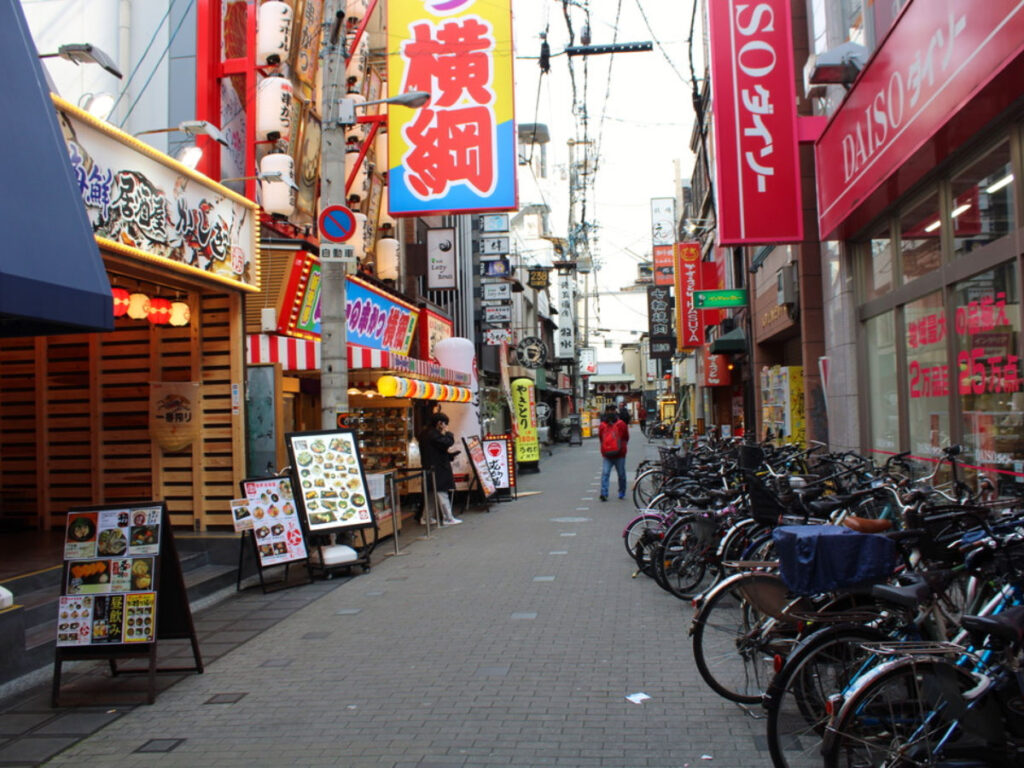 Shops and bicycles lined up on a back street in Namba