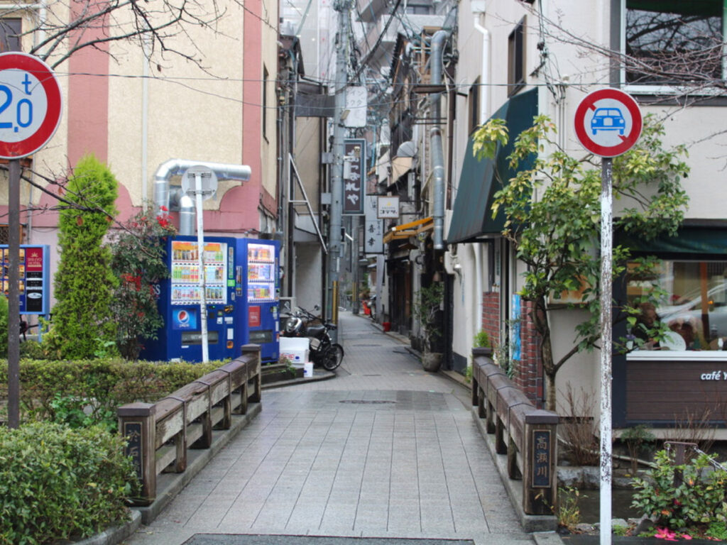 Signs and vending machines on the Back streets of the Shimogyo neighborhood