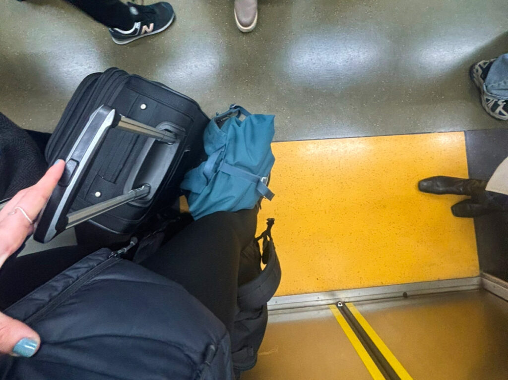 Author Sky Ariella carrying her bags on the train in Japan