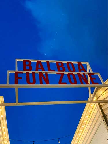 The Balboa Fun Zone signage at the entrance at night