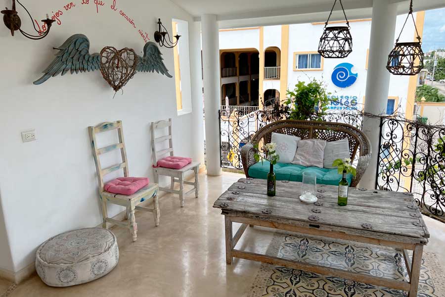 Tables and chairs on a balcony in Live Tulum