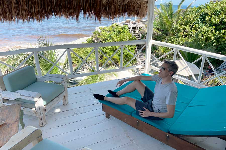 Nate sitting on a chair in a balcony at Posada Punta Piedra