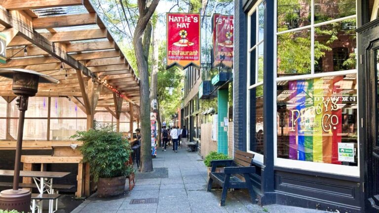 View of the people walking along a pathway surrounded with shops at Ballard Ave