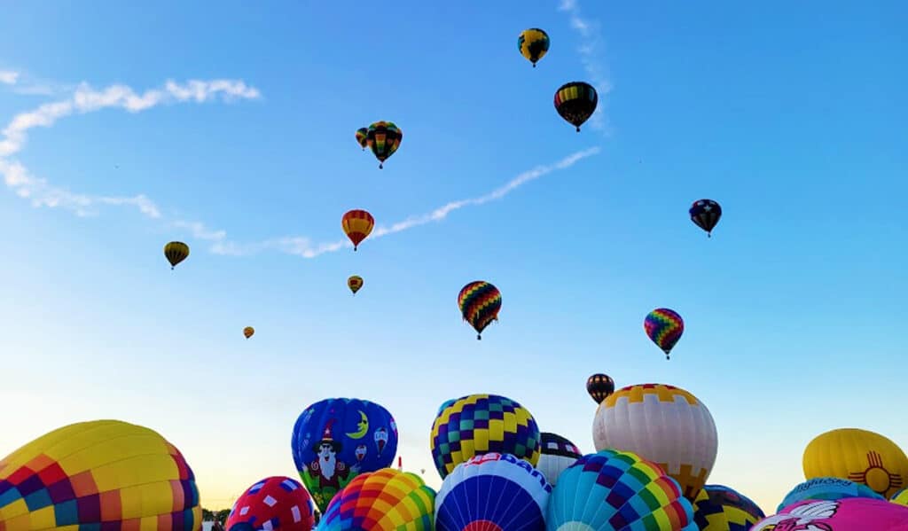 Colorful hot air balloons up in the sky of Albuquerque during the 2021 Balloon Fiesta