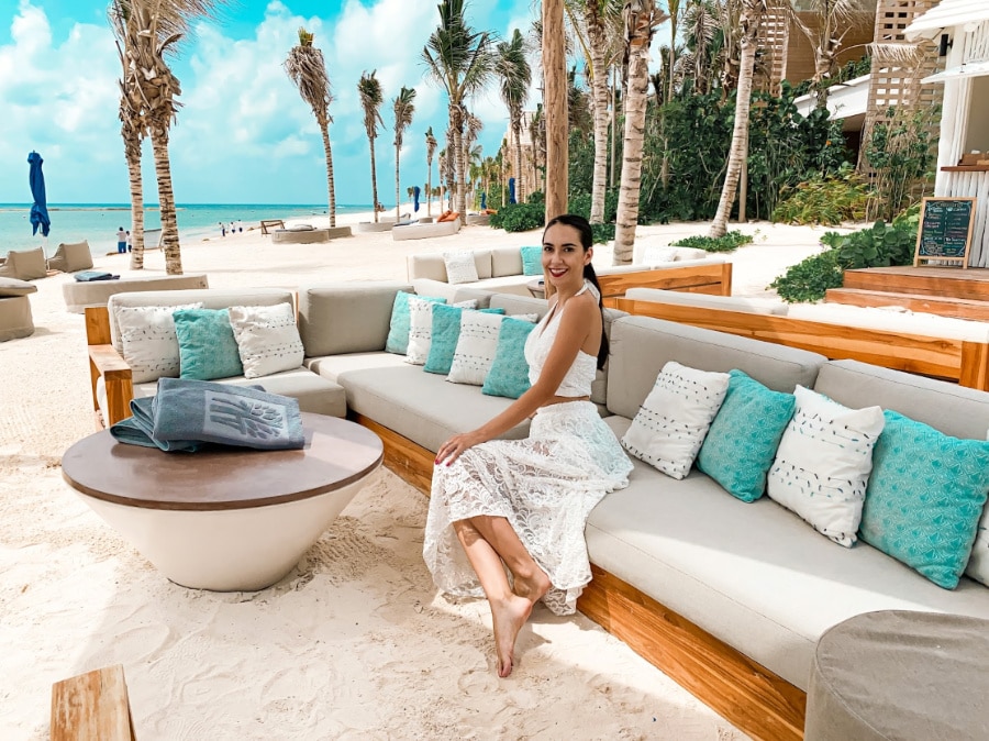 Clara sitting on a couch in Banyan Tree Mayakoba