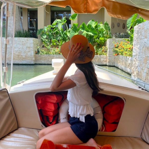 Clara sitting on a boat in Banyan Tree Mayakoba