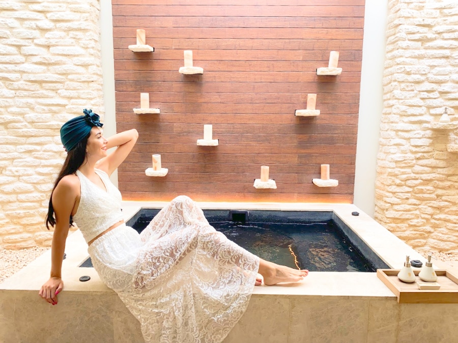 Clara sitting on the edge of a jacuzzi