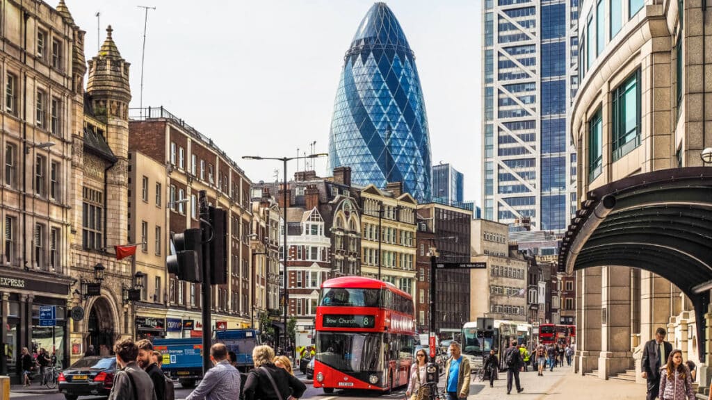 A glimpse of the famous Gherkin building behind the busy Shoreditch high street