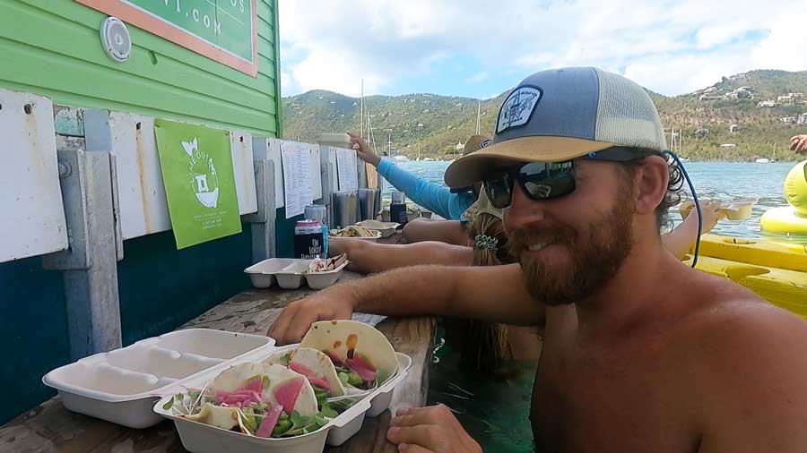 Travel Lemming writer Andrew enjoying her tacos on a bar stool in Lime Out
