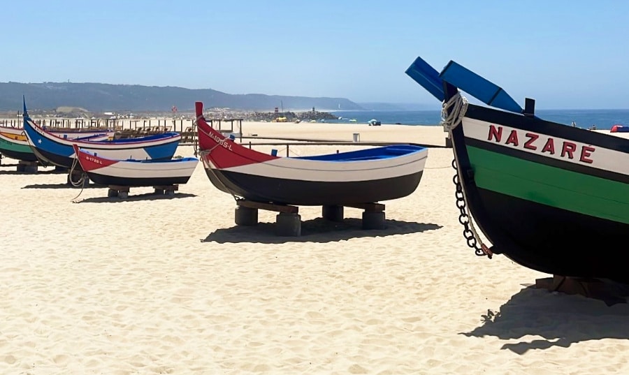 Colorful traditional boats on the shore of Nazare