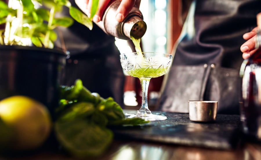A bartender preparing a cocktail on the glass