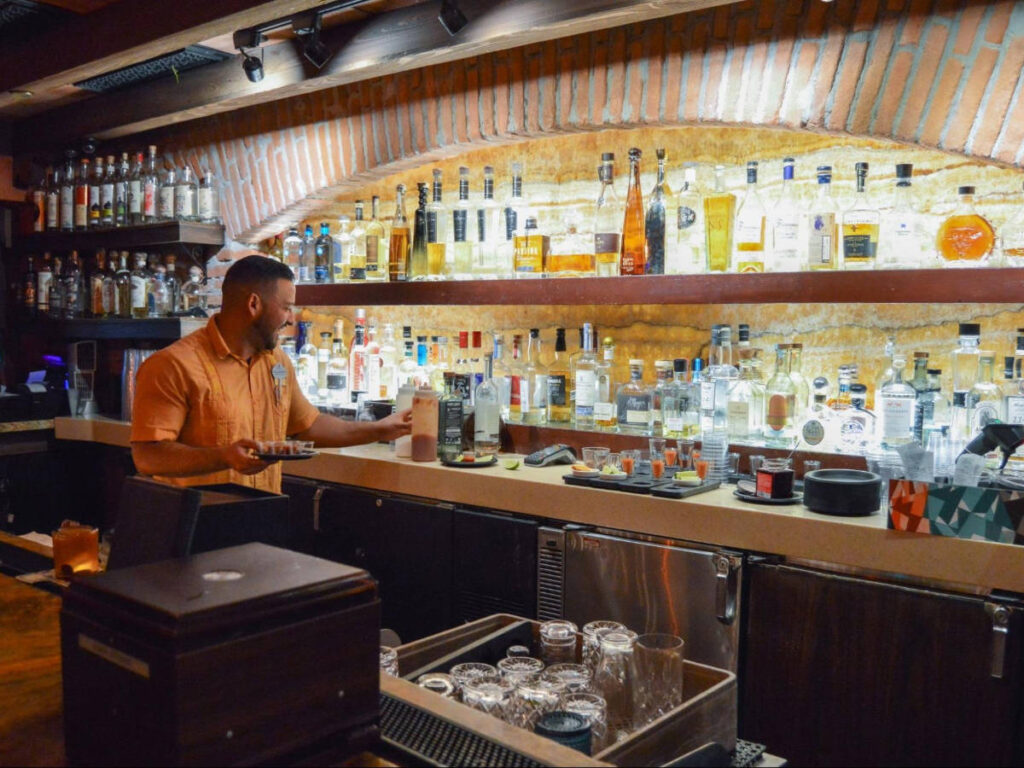 A bartender mixing drinks at the La Cava del Tequila