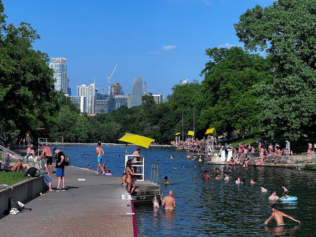People swimming and relaxing at Barton Springs Pool