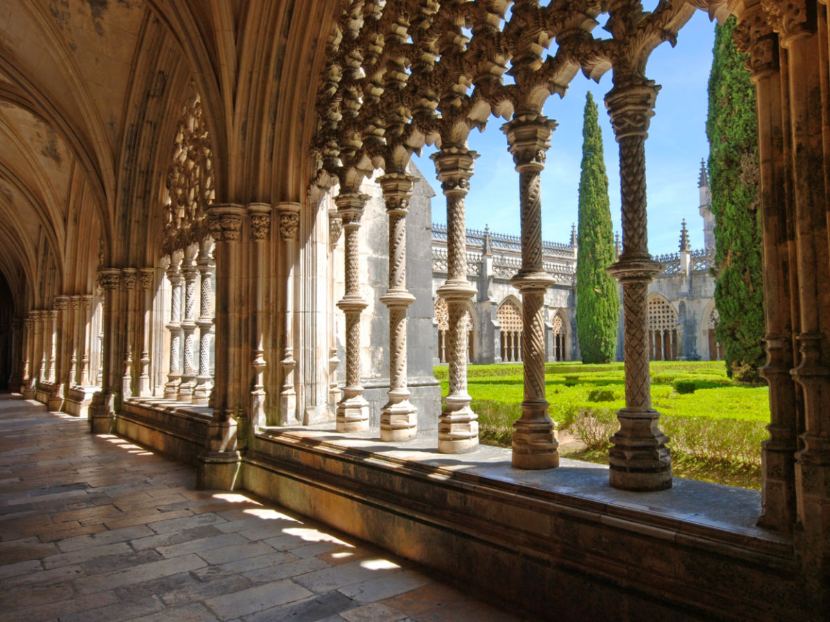 Stone cloister in manuelino style and beautiful garden in Batalha Monastery