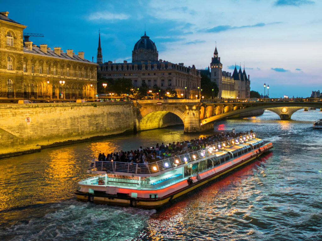 People on the Bateau Mouche on Seine river at night