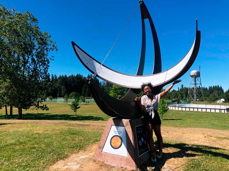 The author posing for a photo beside the Equatorial Sundial in Battle Point Park 