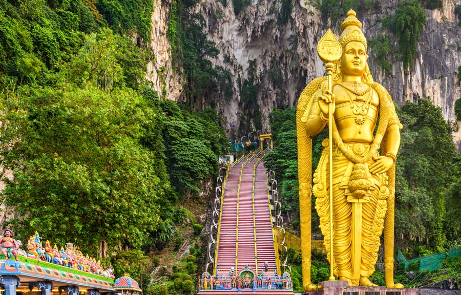 A huge golden statue at the entrance to Batu Caves