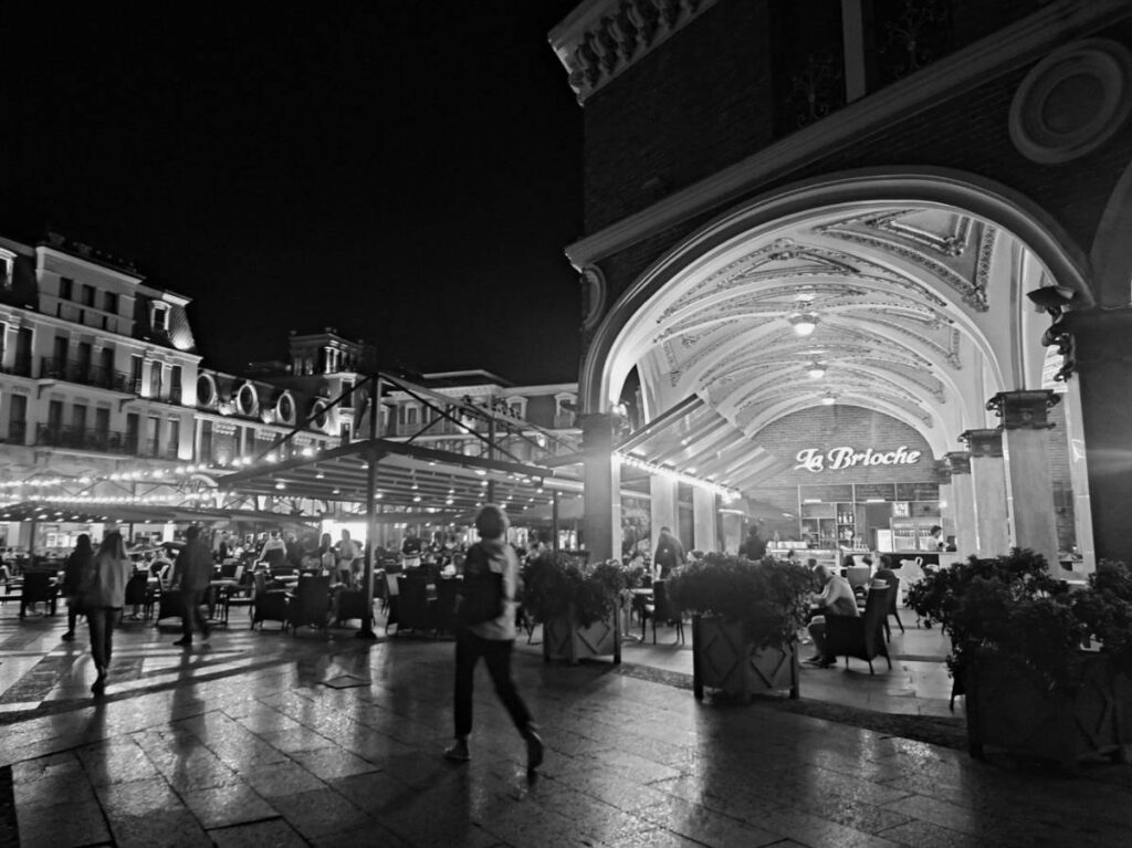 A black and white photo of the Batumi Piazza at night