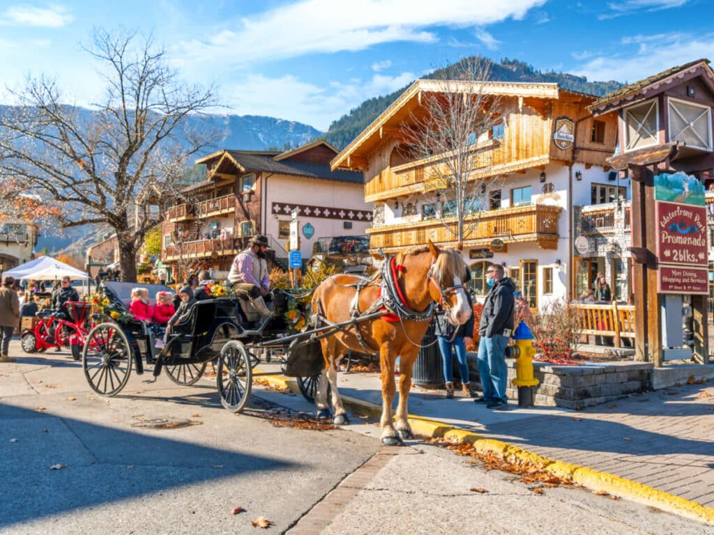 A horse carriage with tourists in the colorful Bavarian themed village of Leavenworth