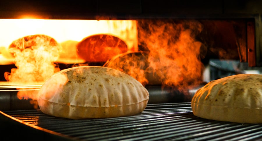 A smoky freshly baked flatbreads inside the oven