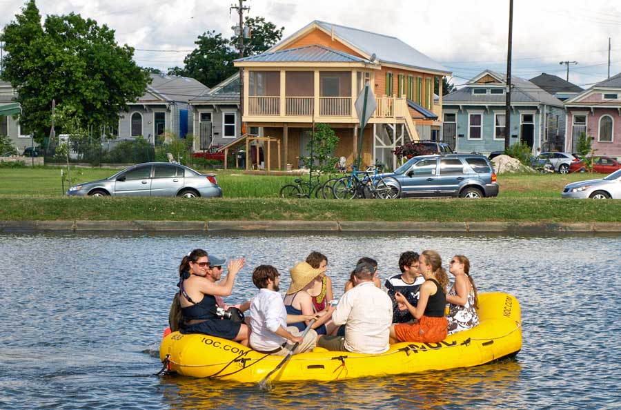People enjoying their day while on an inflatable raft sailing in the Bayou St. John water