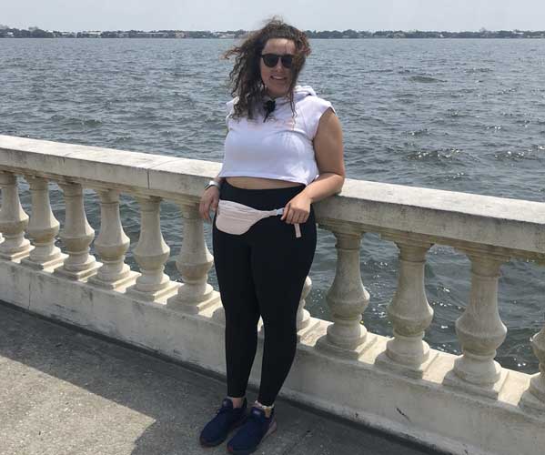 The author Marina Martinelli posing near the rails at the famous Bayshore on one windy day